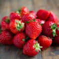 Fresh strawberries on wooden table.