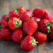 Fresh strawberries on wooden table.